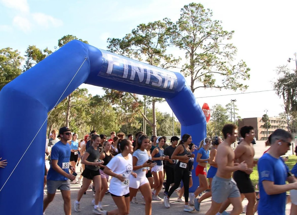 VOP runners at the annual 5K under the finish arch