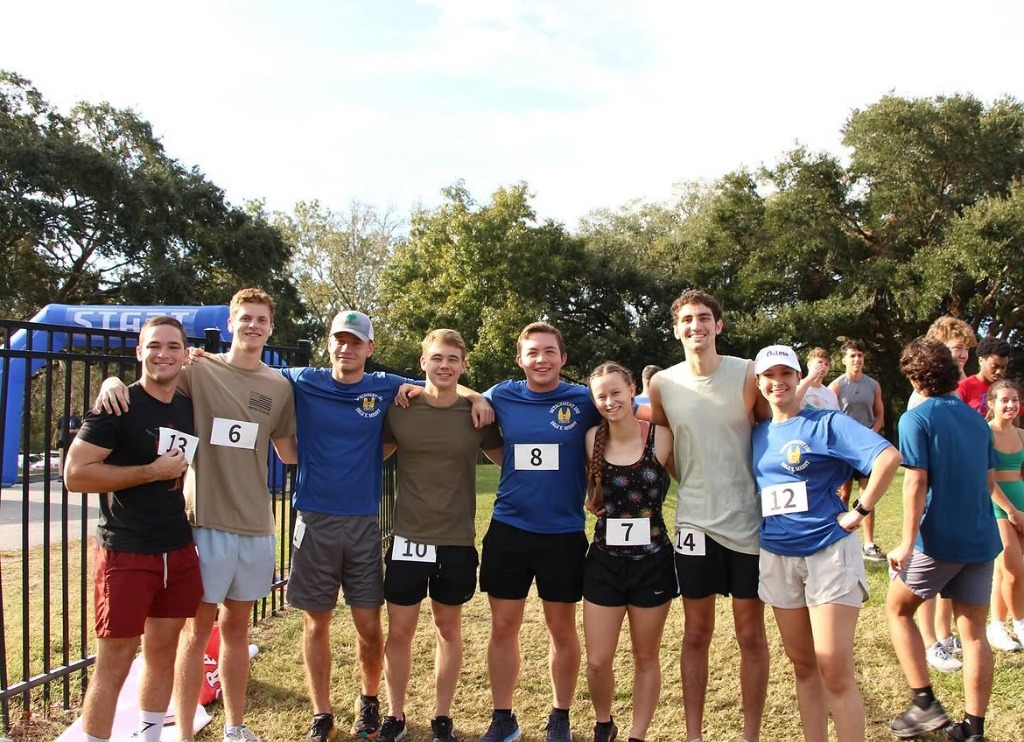 VOP student leaders and runners united with arms around each other at the 5K